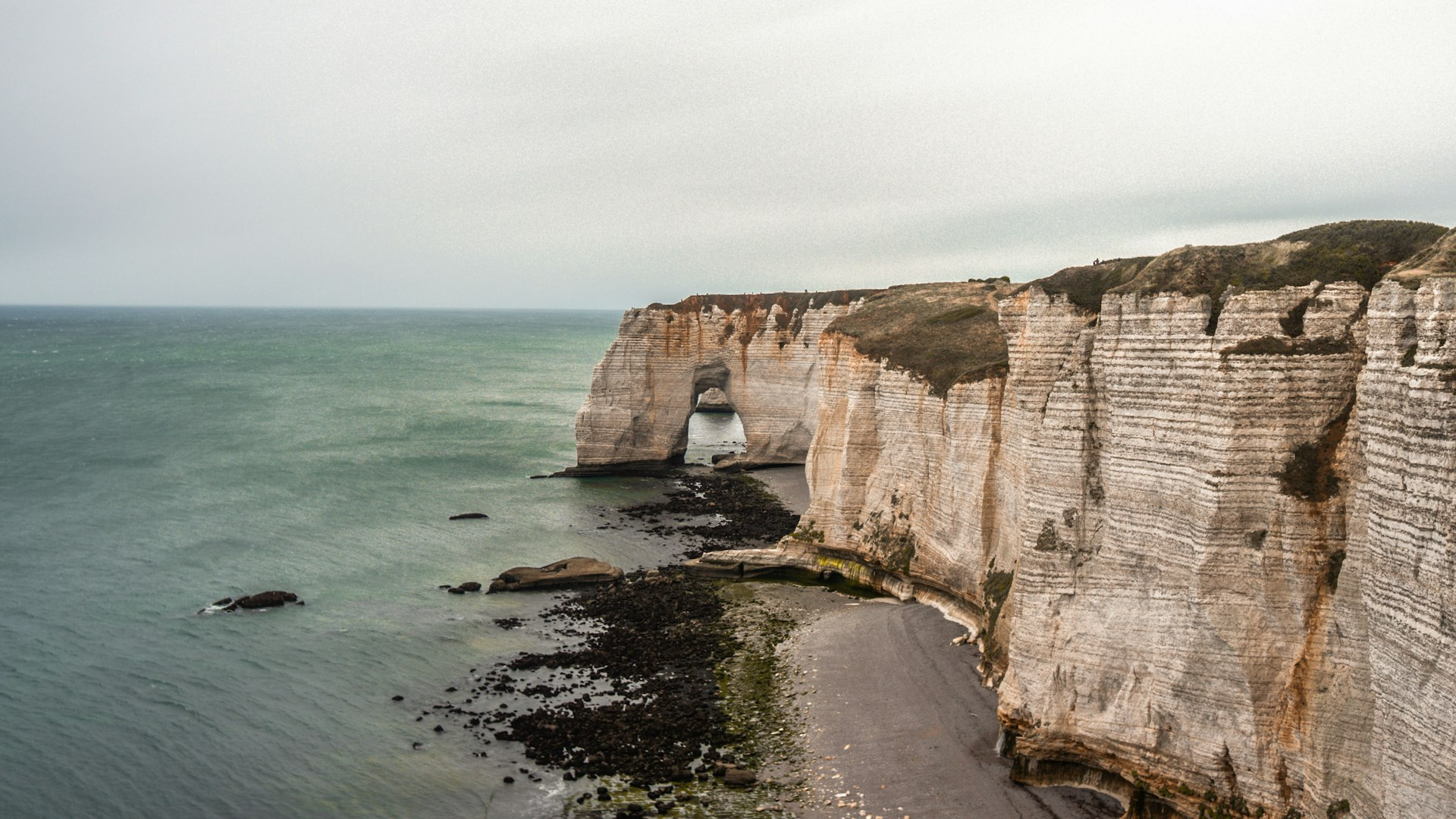 brown rock formation on sea during daytime